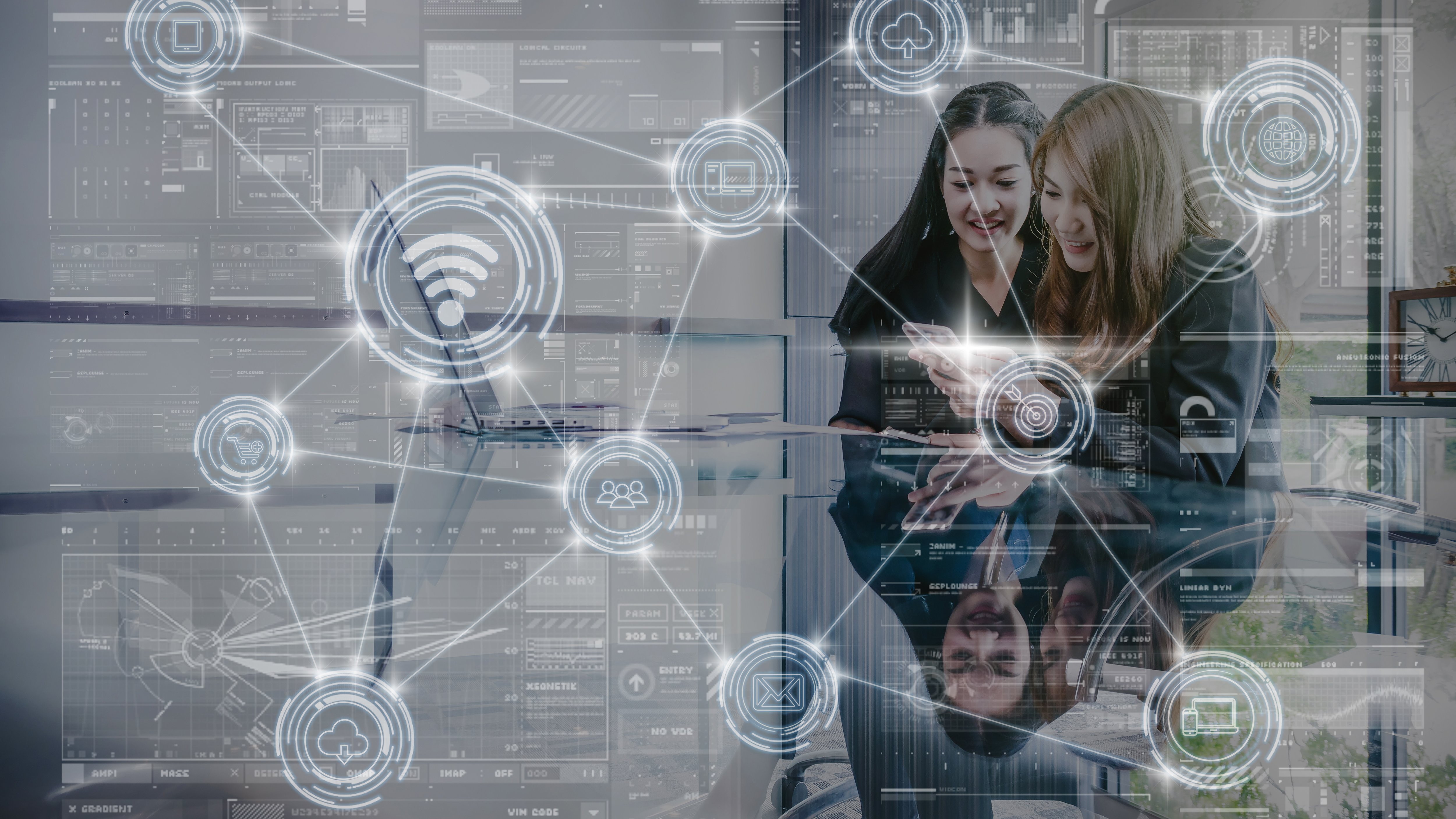 Two young Asian Businesswoman using laptop in modern workplace