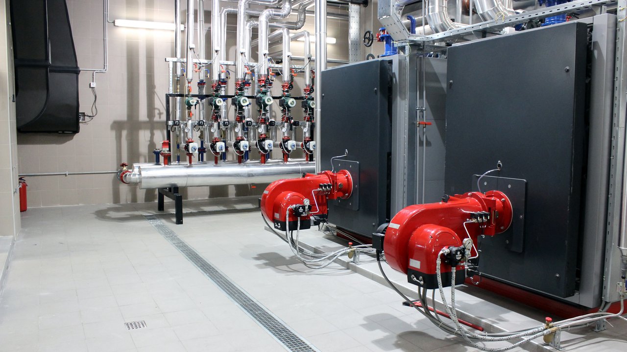 Interior of industrial building room with boiler and cooling system for cooling and heating